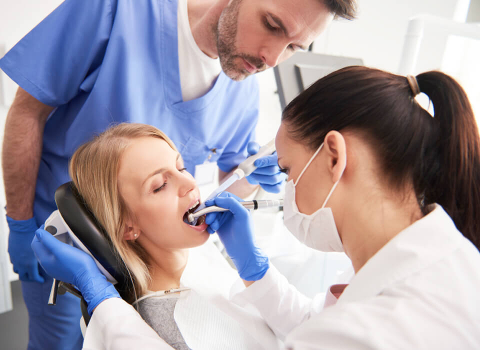Image of dental , her assitant and patient in truglo modern dental office