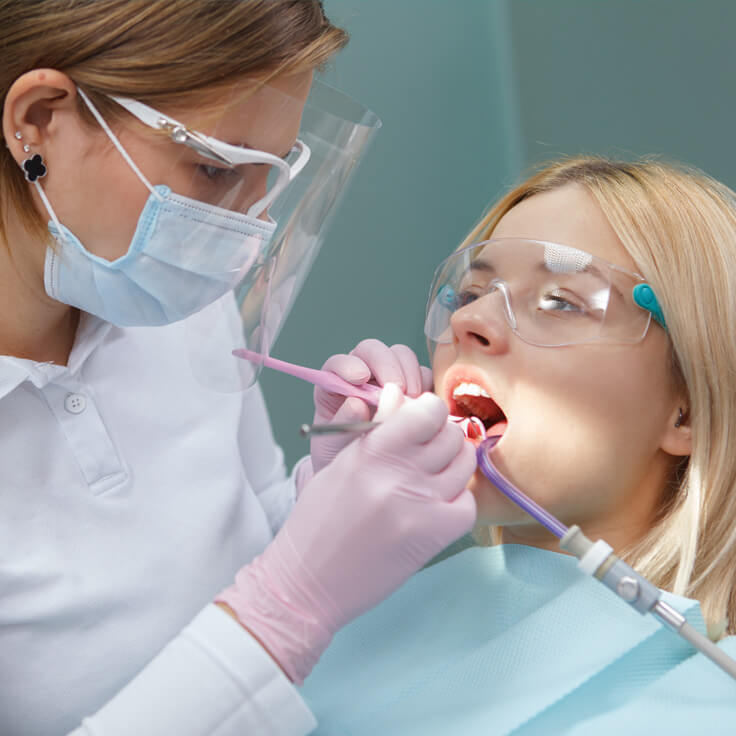 Dental doctor working with her paitent